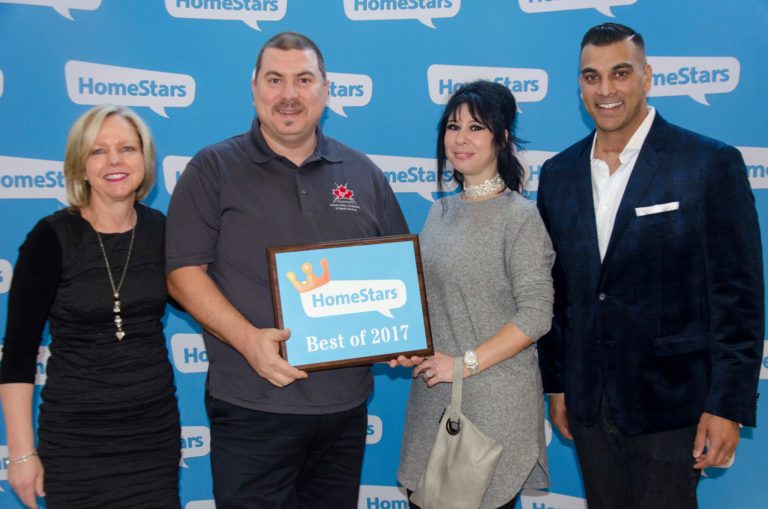 Mark Aydin accepting a HomeStars Best of Award for Victorious Carpet & Flooring